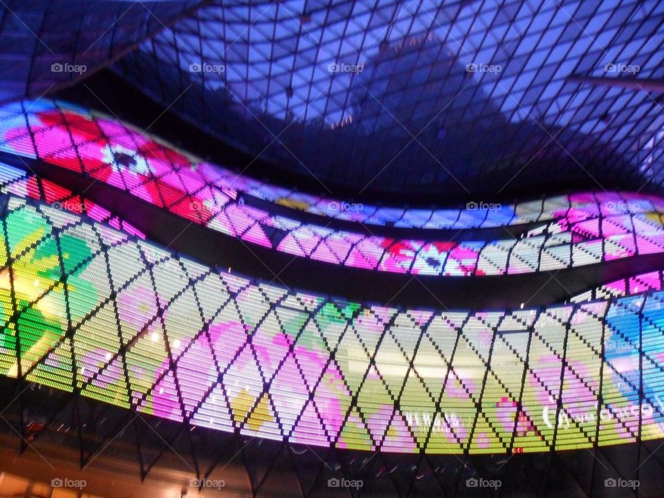 The alluring Ion Orchard with its undulating glass facade lit up by