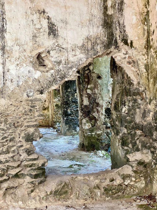 Looking through a hole in the wall of an old Spanish hacienda