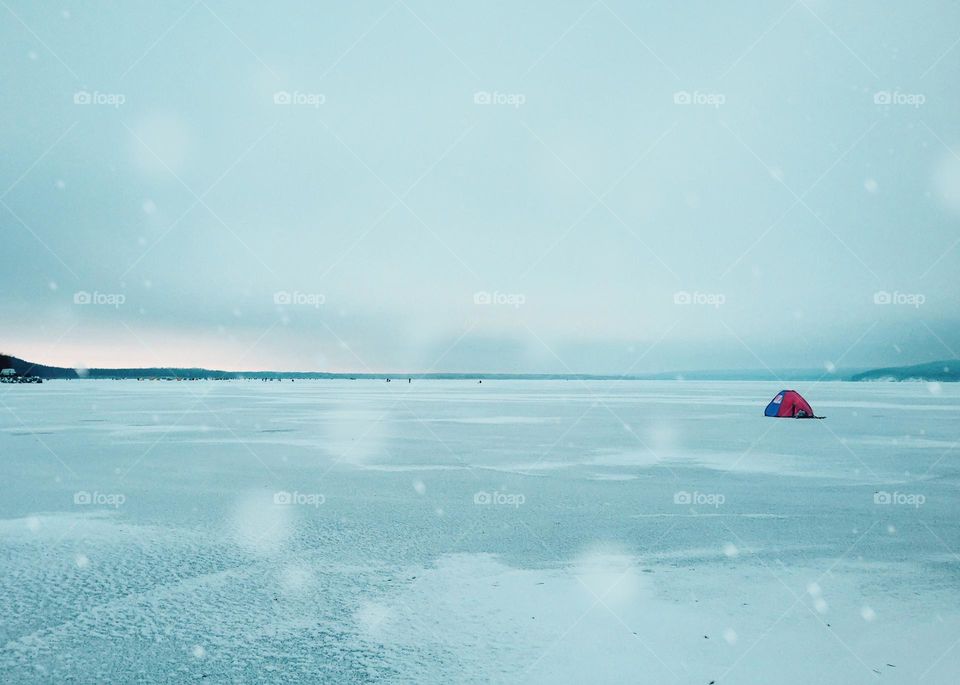 Triangle tent on frozen lake 