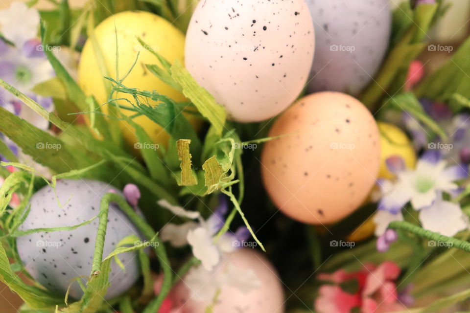 Easter eggs arranged in a bouquet with fake grass 