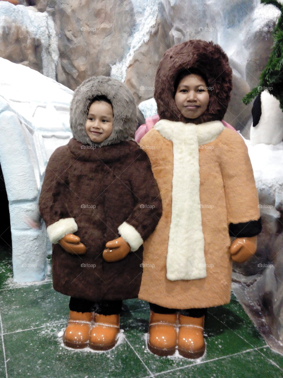 Asian mother and son in esquimo costume