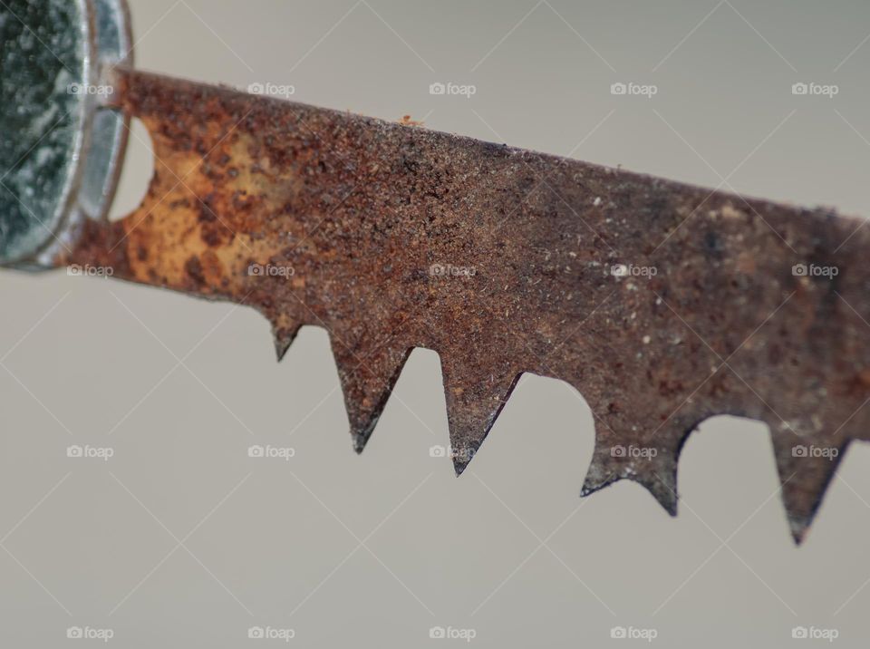 Close up of part of an old rusty saw