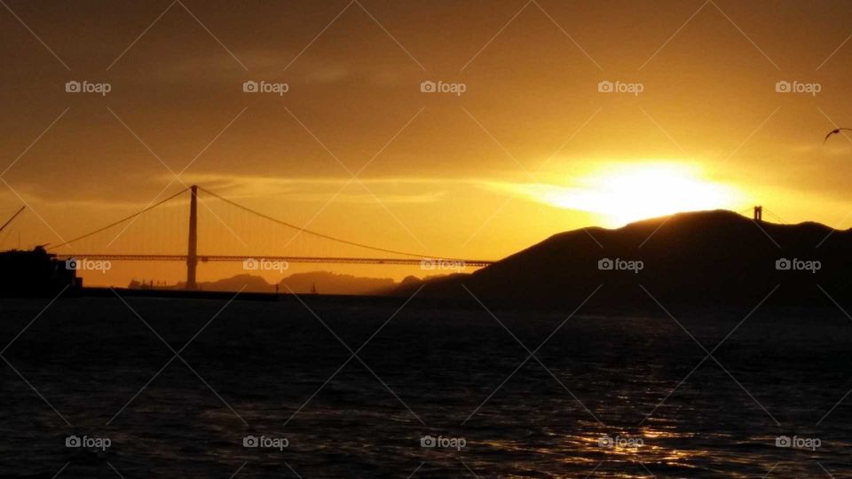 spectacular sunset with the golden gate of in the distance, can't beat a sunset on the California coast