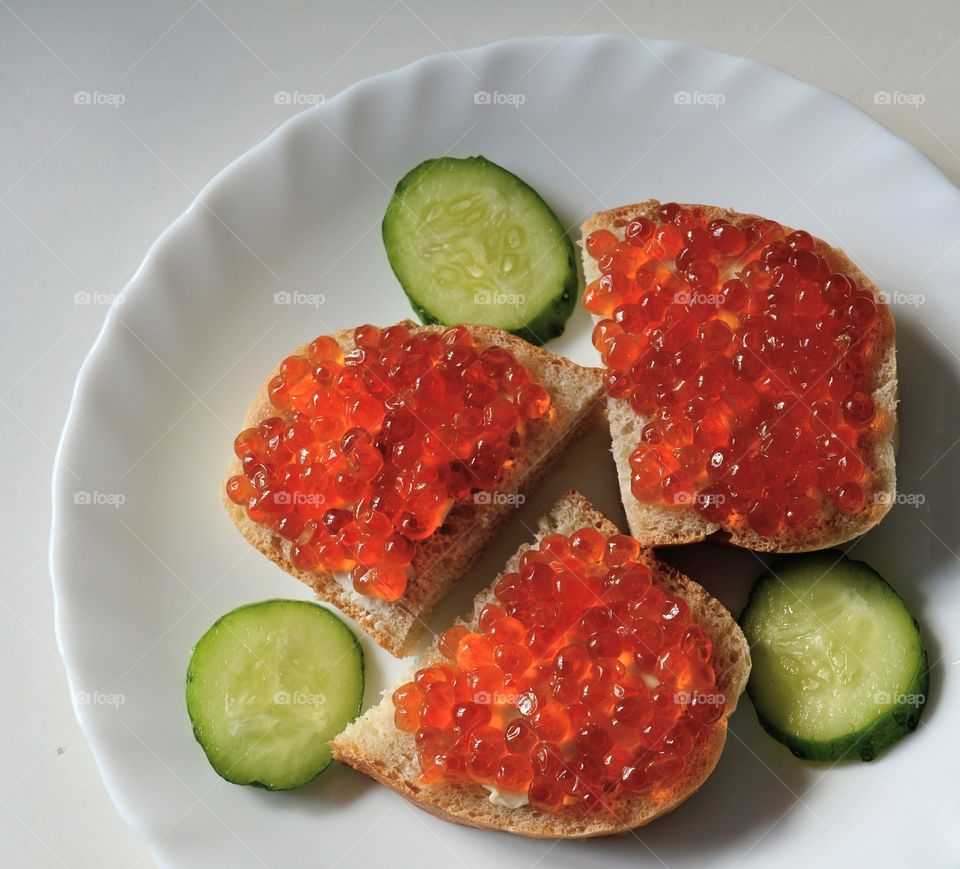 sandwiches with red caviar on a plate