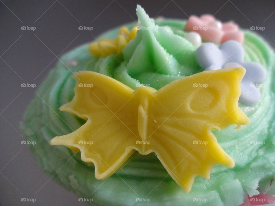 yellow butterfly on cupcake