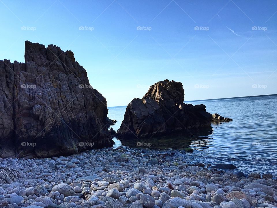 Beautiful landscape at the ocean with rock, cliff and stones