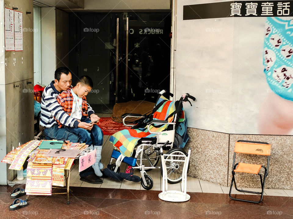 In the corner of the street in Taipei, they are the most vulnerable ethnic group. Dad carries children with smart obstacles to sell things in the most prosperous locations. What a conflicting picture!