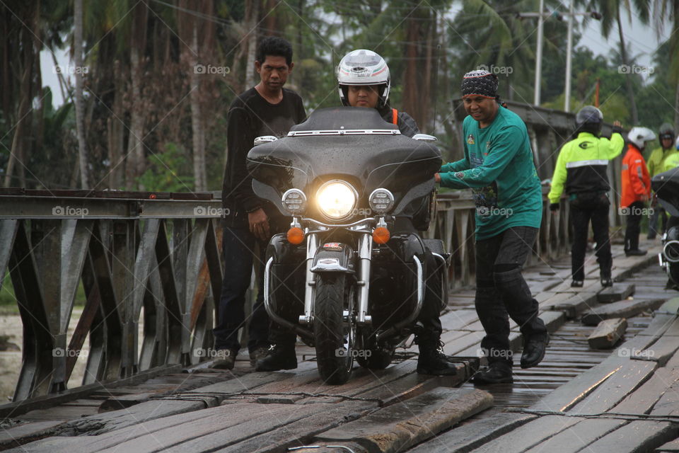 Convoys of motorbike riders pass through extreme bridges in Palu, Central Sulawesi. This moment became a spectacle of local residents