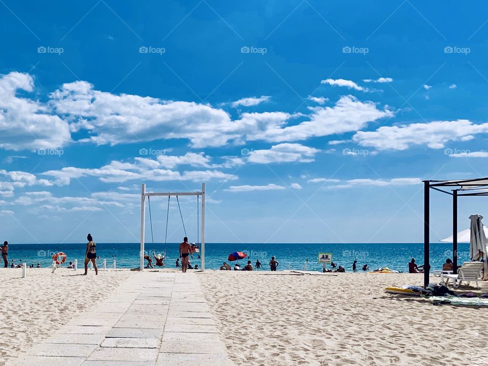 gorgeous white sand beach with swings. The Black Sea. Summer vacations.