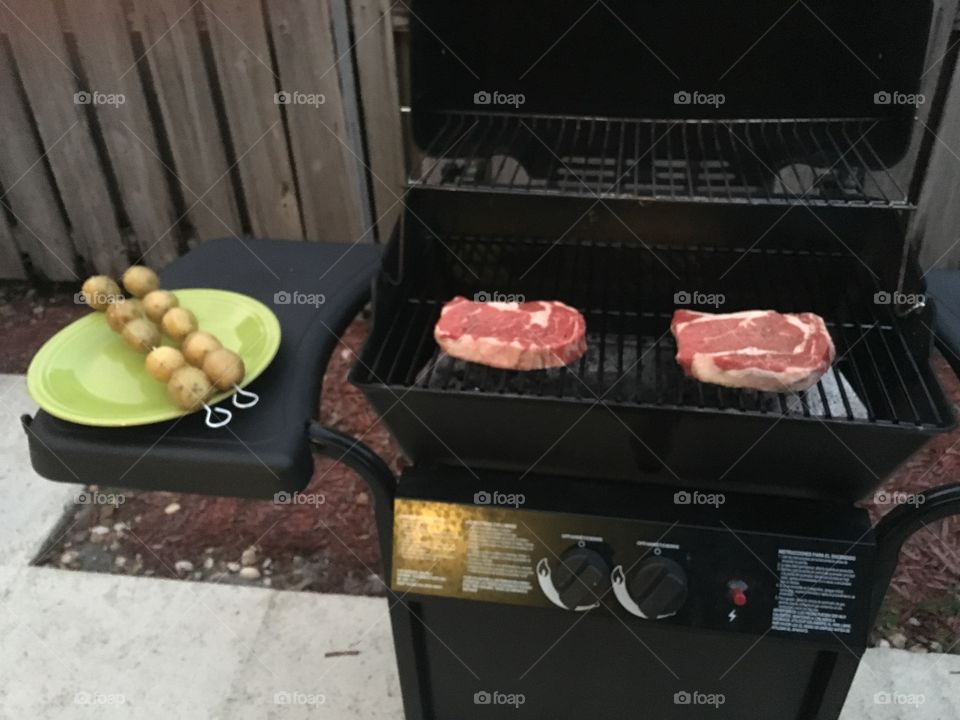 Steak and potatoes . Grilling steak and potatoes!