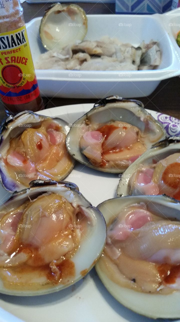 raw clams hot sauce and steamed fish