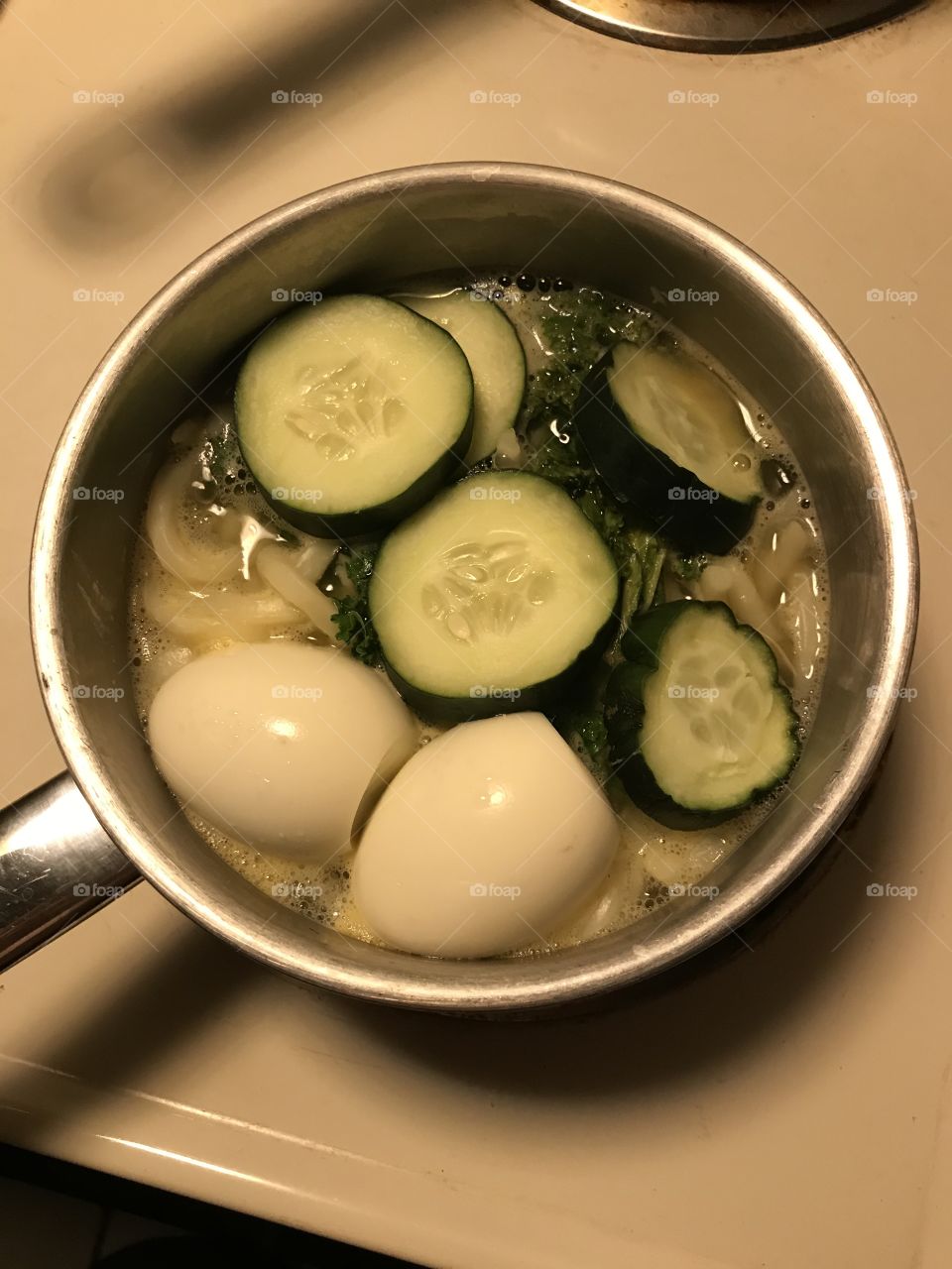 Udon dinner being cooked. Vegetables and eggs are added to spice up the Japanese noodle.