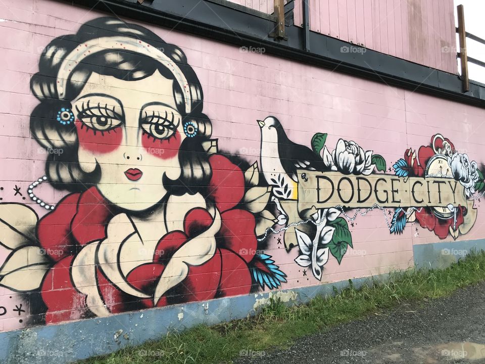 A colourful  and unique mural on the back of A building on second street  in Cumberland, British Columbia.