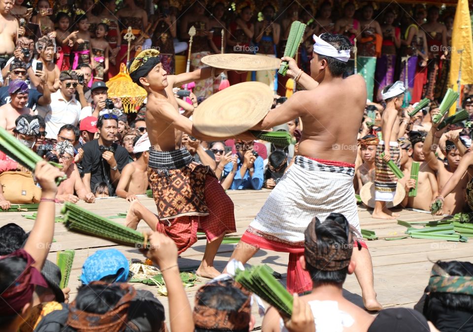 Men fight each other with thorny pandan leaves in the village of Tenganan in Bali, Indonesia during the annual perang pandan festival.