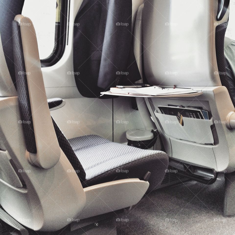 Jacket hanging above empty seat in train