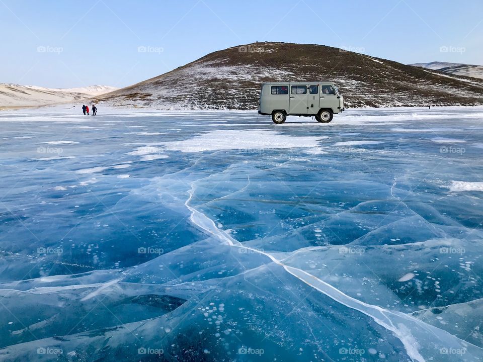A van on ice lake in famous place of Bubble below Russia