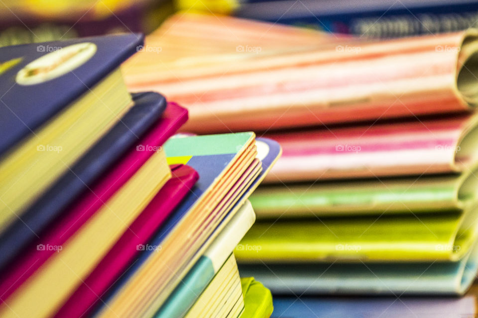 Close-up of some piles of colored books