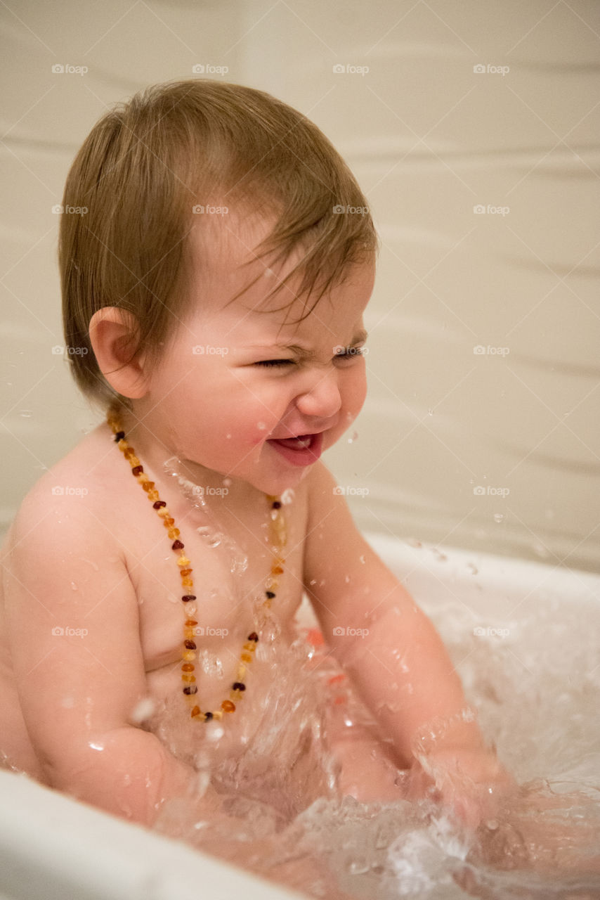 Cute baby boy bathing in bathtub