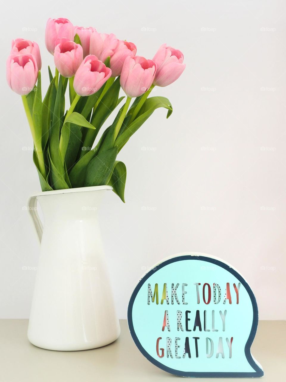 Pink tulips vase on a table