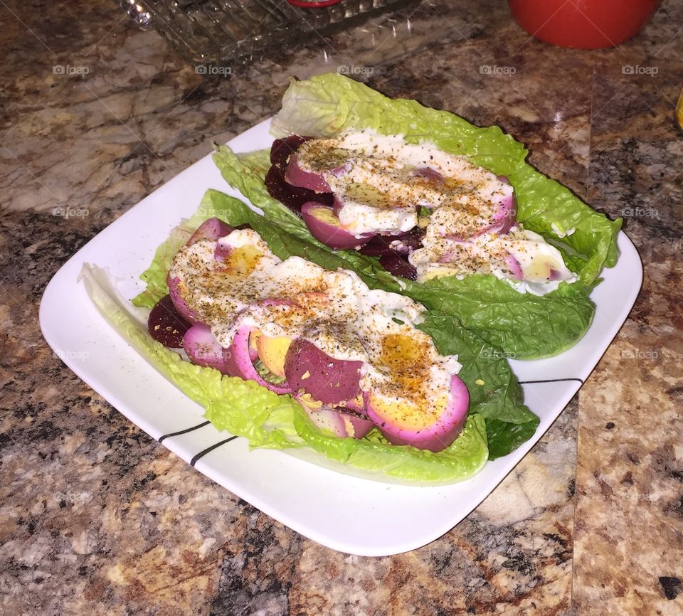 My pickled eggs and red beets on romane lettuce with mayonnaise, ring peppers, and salt and pepper. 