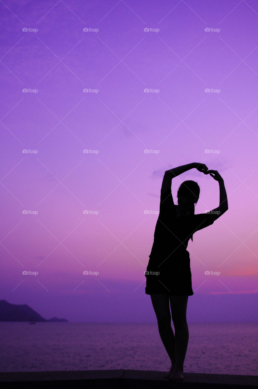 Silhouette of woman by the sea