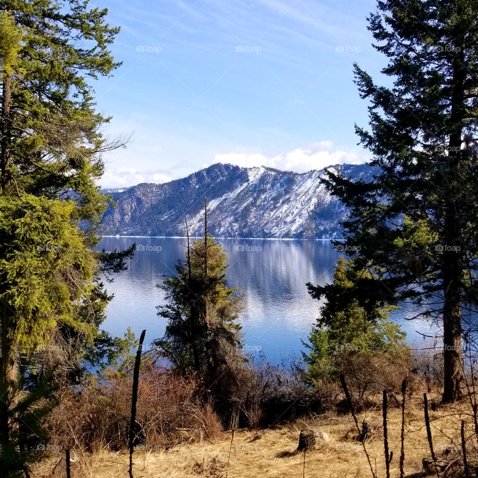 view of snow covered mountain across a lake on a spring hike