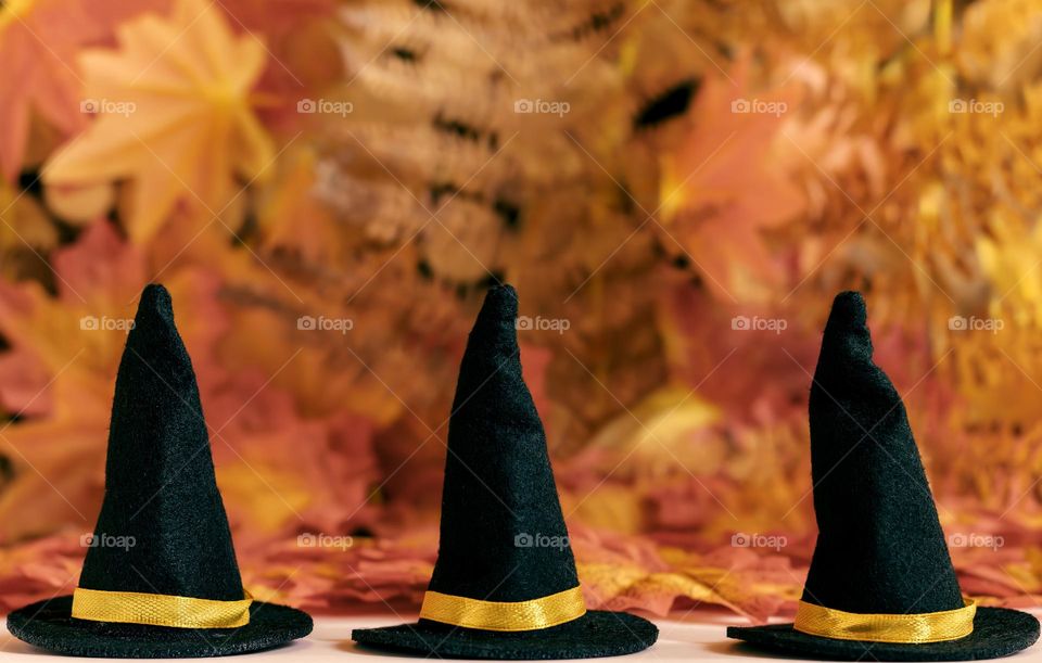 3 witches hats against a autumnal background 