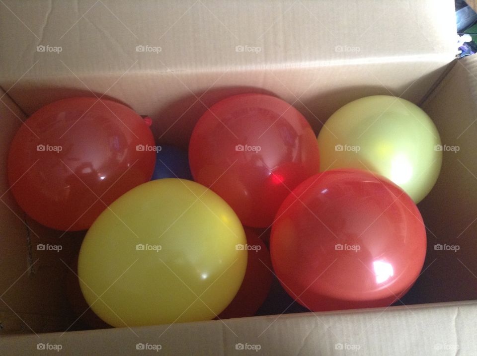 Box of red balloons