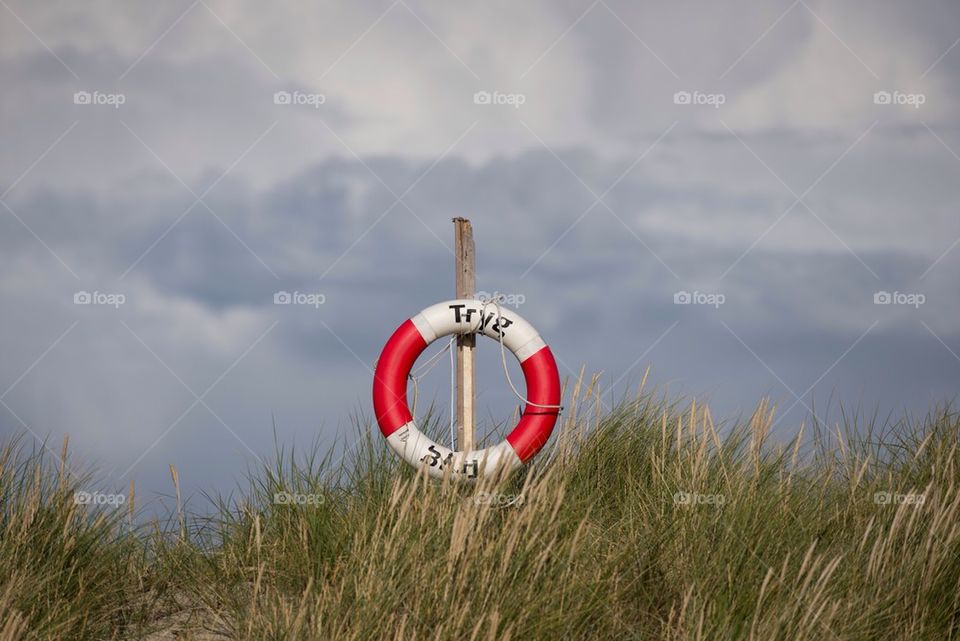 Lifeguard tube hanging on a pole 