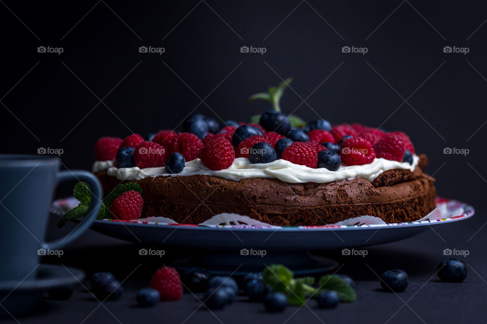 Berries fruit on cake with coffee drink