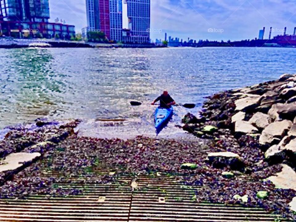 At the end of his kajaking exercising session at Newtown Creek in Long Island City, Queens, NY our friend is ready to come back onto the land. August 2021. Hypnotic Productions