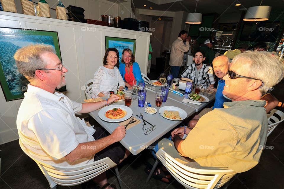 Family people eating inside restaurant 