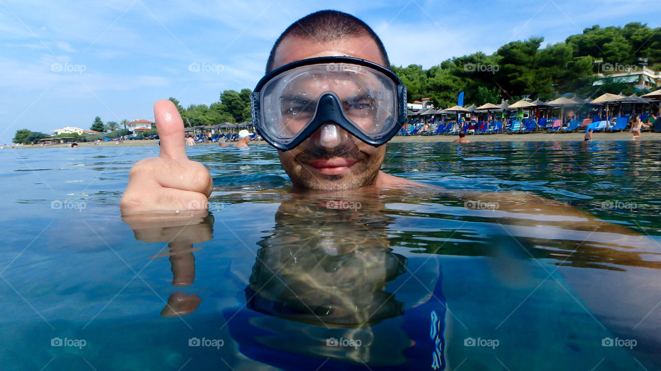 Snorkeling man showing thumbs-up