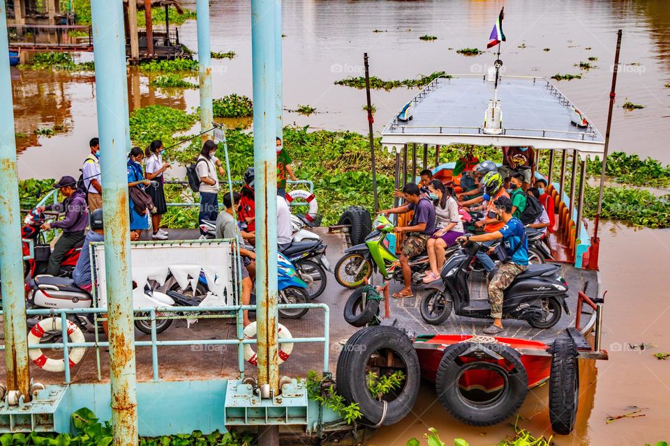 People wait by a ferry boat pier at the Chao Phraya River in Ayutthaya Thailand Southeast Asia