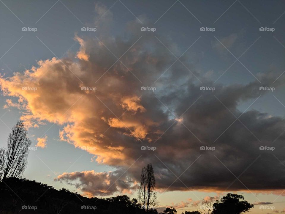 sunsetting through the fluffy clouds