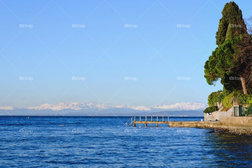 Scenic view of the Alps mountains against blue sky and Adriatic sea in Slovenia.