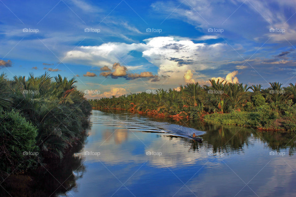 Martapura river reflects the bright blue sky that afternoon, in "the city of a thousand rivers", Banjarmasin, Indonesia.