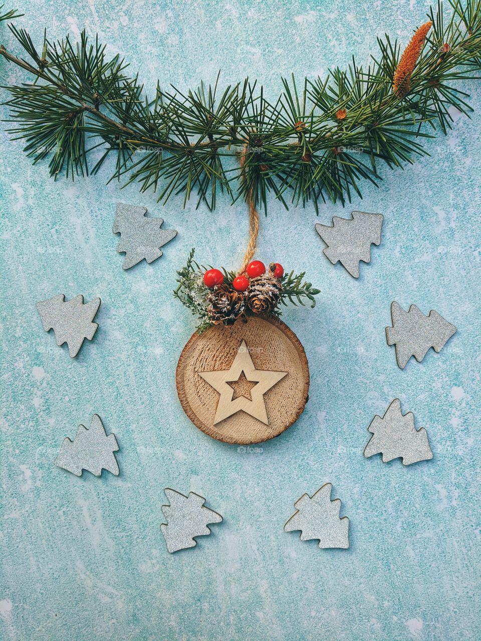 Christmas or New Year composition.  Fir branches with festive decor on a light blue background. Top view. Flat lay.