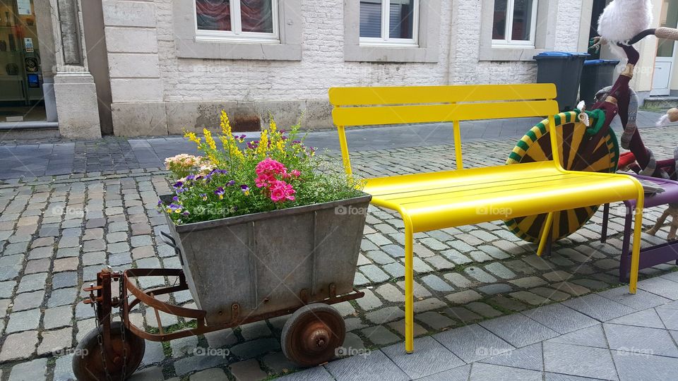 bench yellow flowers street