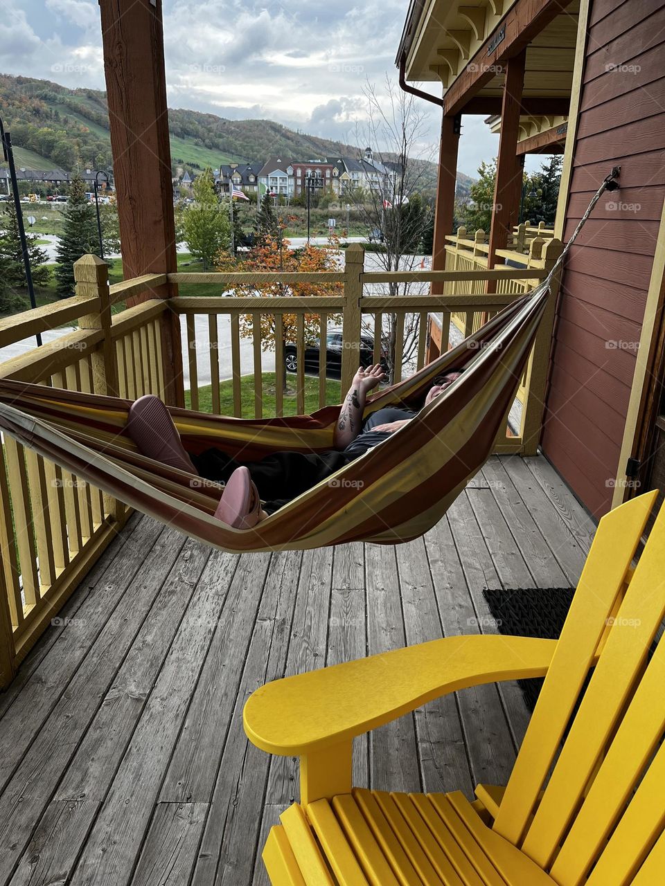 Blue mountain collingwood , balcony view of mountains and village , hammock and muskoka chair on balcony 