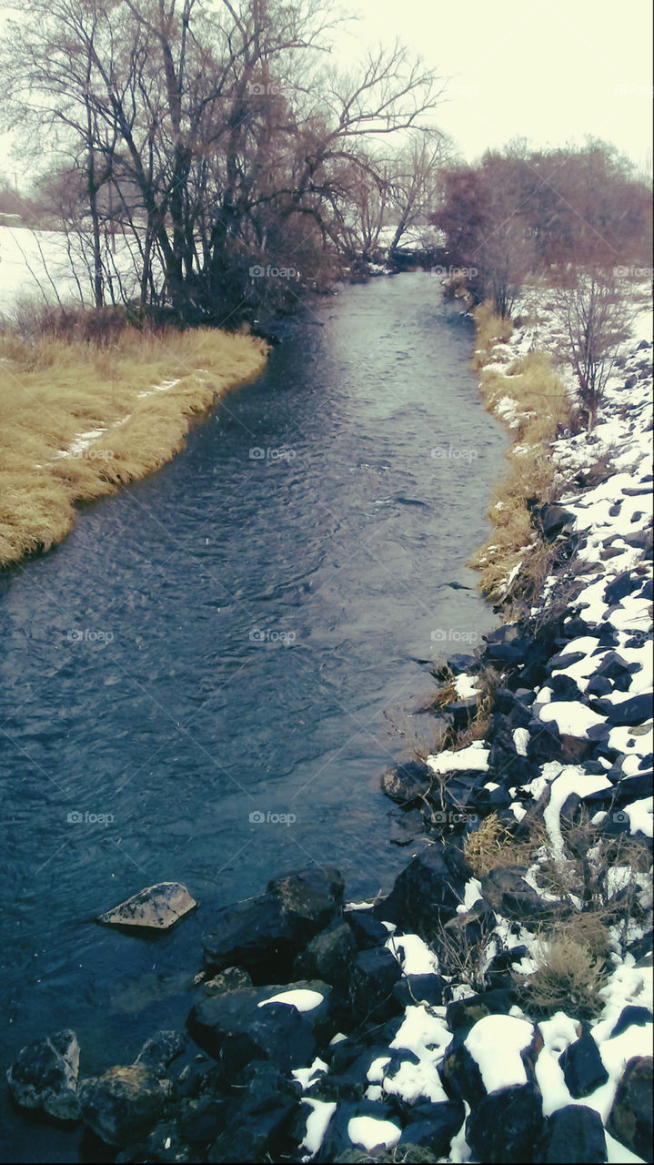 image of beautiful blue stream or river in winter