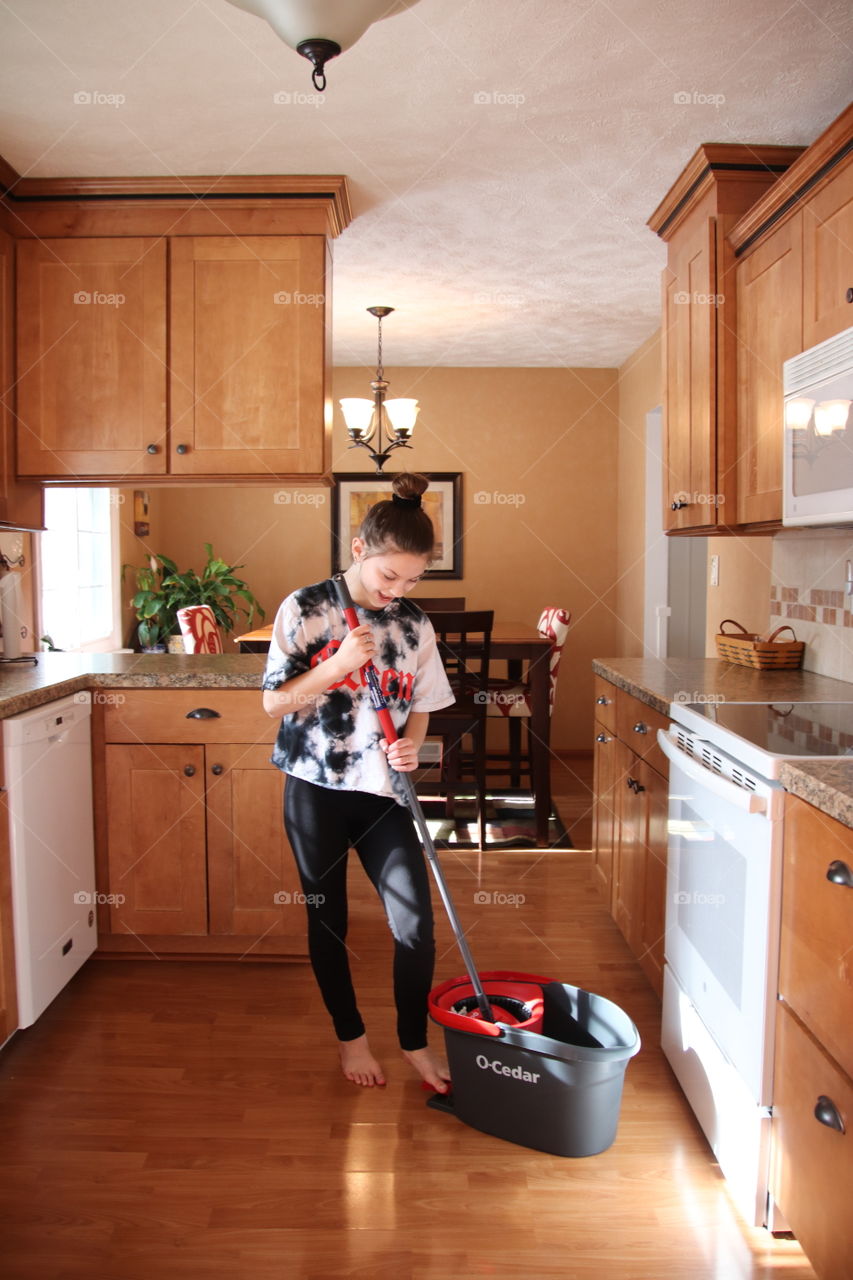 Girl using O-Cedar mop and bucket 