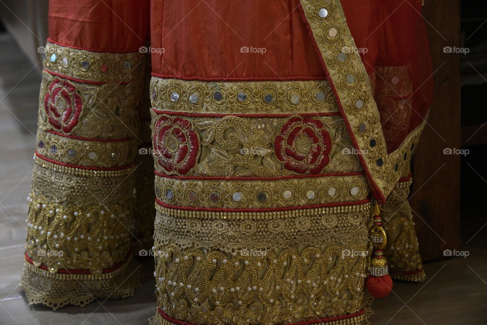 Embroidery, mirror and bead work on a long silk skirt called Lehenga from India.