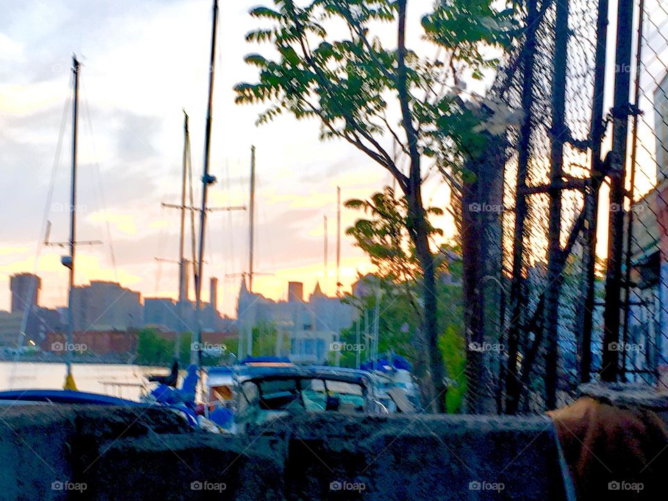 A view over the waters of the East River at Newtown Creek in Long Island City, Queens, NY with sailboats in the twilight hour of upcoming nightfall makes a lovely topic to photograph. 2019. Hypnotic Productions
