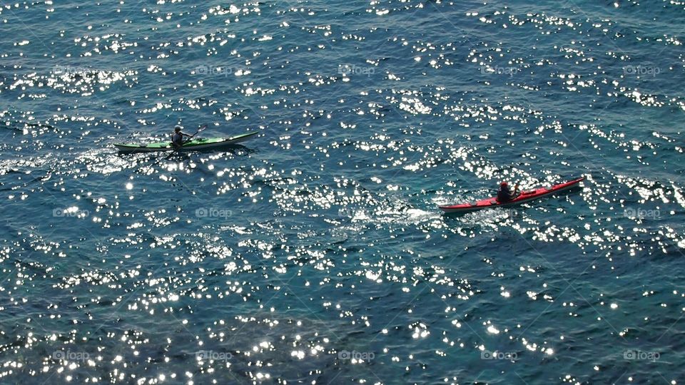 Sea. Reflections. Kayaks