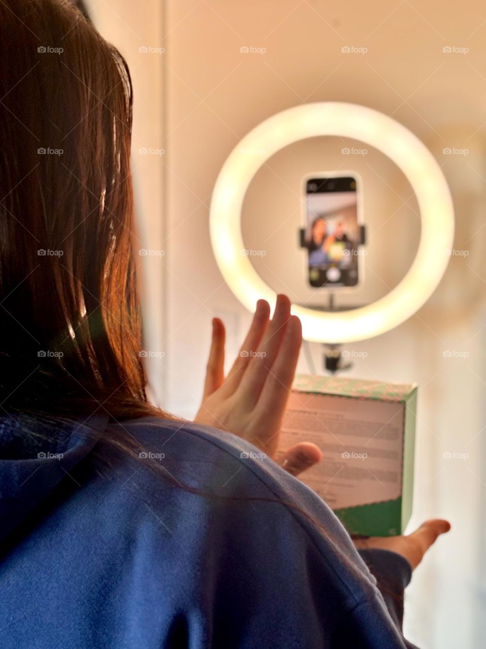 Video creator filming with ring light