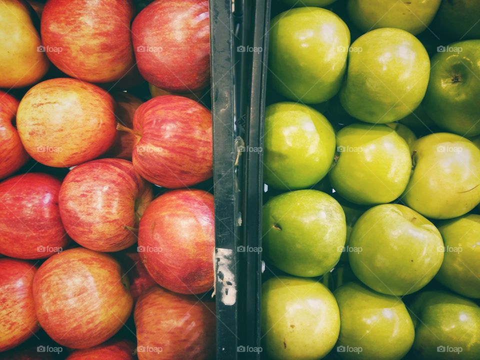 A bascket full of green and red apples