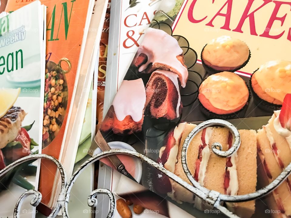 Recipe books in old cast iron painted wire rack