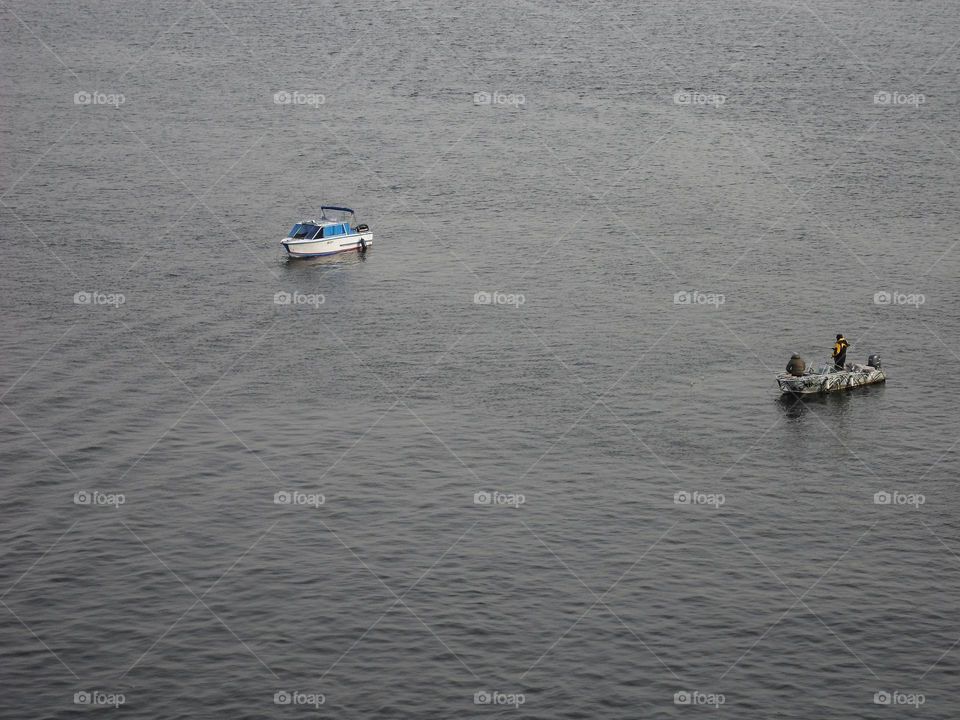 two fishing boats are fishing on the Dnieper river