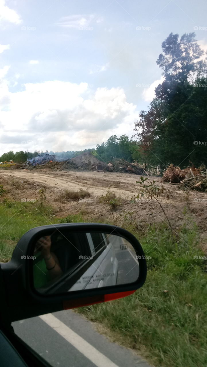 Burning tree stumps making way for new highway